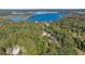 Aerial view showing home on wooded lot near lake at 12750 Se 119Th Ct, Ocklawaha, FL 32179