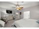 Spacious bedroom with a large TV and ensuite bathroom access at 12750 Se 119Th Ct, Ocklawaha, FL 32179