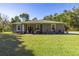 Gray house with white columns and landscaping at 12750 Se 119Th Ct, Ocklawaha, FL 32179