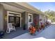 Inviting front porch with rocking chairs and well-manicured landscaping at 12750 Se 119Th Ct, Ocklawaha, FL 32179