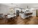 Kitchen features island with seating, stainless steel appliances, and hardwood floors at 12750 Se 119Th Ct, Ocklawaha, FL 32179