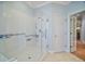 Bathroom with a large walk-in shower and grab bars at 13077 Se 86 Ct, Summerfield, FL 34491