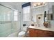 Bathroom with a walk-in shower and single vanity at 13077 Se 86 Ct, Summerfield, FL 34491