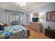 Main bedroom with wood flooring and access to balcony at 13077 Se 86 Ct, Summerfield, FL 34491