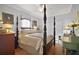 Bedroom with a four-poster bed and sitting area at 13077 Se 86 Ct, Summerfield, FL 34491