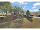 Landscaped front yard with lush grass, palm tree, and stone accents at 13077 Se 86 Ct, Summerfield, FL 34491