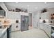 Modern kitchen with stainless steel appliances and white cabinets at 13077 Se 86 Ct, Summerfield, FL 34491