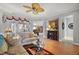 Spacious living room featuring hardwood floors, fireplace, and comfy seating at 13077 Se 86 Ct, Summerfield, FL 34491