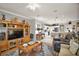 Living room with open kitchen and built-in entertainment center at 13077 Se 86 Ct, Summerfield, FL 34491