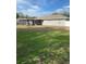 Large backyard with a grassy area and screened patio at 13410 Sw 3Rd Ct, Ocala, FL 34473