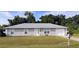 Ranch-style house with gray siding, attached garage, and a well-maintained lawn at 13410 Sw 3Rd Ct, Ocala, FL 34473