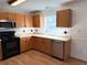 Bright kitchen with wood cabinets, laminate flooring and modern appliances at 13410 Sw 3Rd Ct, Ocala, FL 34473