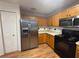 Kitchen with stainless steel appliances and wood cabinets at 13410 Sw 3Rd Ct, Ocala, FL 34473