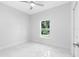 Simple bedroom with a window and marble floors at 15148 Se 61St Ct, Summerfield, FL 34491