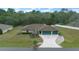 Aerial view of house, showing landscaping and driveway at 16 Hickory Loop Way, Ocala, FL 34472