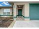 House exterior showcasing a front entrance and attached two-car garage at 16 Hickory Loop Way, Ocala, FL 34472