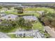 Aerial view of community with lake and parking at 21202 Sandalwood Dr # 21-202, Wildwood, FL 34785