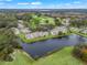Aerial view of community near golf course and lake at 21202 Sandalwood Dr # 21-202, Wildwood, FL 34785