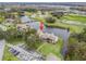 Aerial view of condo near a lake and green space at 21202 Sandalwood Dr # 21-202, Wildwood, FL 34785