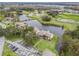 Aerial view of community with lake and parking at 21202 Sandalwood Dr # 21-202, Wildwood, FL 34785