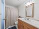 Light and airy bathroom with a wood vanity and tub at 21202 Sandalwood Dr # 21-202, Wildwood, FL 34785