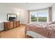 Bedroom with large window and water view at 21202 Sandalwood Dr # 21-202, Wildwood, FL 34785