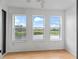 Bright bedroom with three windows offering a scenic water view at 21202 Sandalwood Dr # 21-202, Wildwood, FL 34785