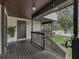 Wooden deck with railing, offering a view of trees and parking at 21202 Sandalwood Dr # 21-202, Wildwood, FL 34785
