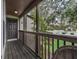Wooden deck with railing and view of a wooded area at 21202 Sandalwood Dr # 21-202, Wildwood, FL 34785