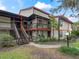 Two-story condo building with stairs and balconies at 21202 Sandalwood Dr # 21-202, Wildwood, FL 34785