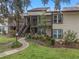 Condo building exterior, showcasing landscaping and walkway at 21202 Sandalwood Dr # 21-202, Wildwood, FL 34785