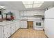 Kitchen with white cabinets and appliances at 21202 Sandalwood Dr # 21-202, Wildwood, FL 34785