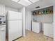 Laundry room with washer, dryer, and shelving at 21202 Sandalwood Dr # 21-202, Wildwood, FL 34785