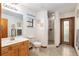 Bathroom includes a shower, toilet and vanity with wood cabinets at 2821 Se 80Th St, Ocala, FL 34480