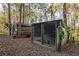 Two dog kennels, one wooden, one metal, in wooded area at 2821 Se 80Th St, Ocala, FL 34480