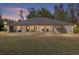 Brick ranch house with a large front porch and expansive lawn at 2821 Se 80Th St, Ocala, FL 34480