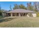 Brick ranch home with large covered porch and expansive lawn at 2821 Se 80Th St, Ocala, FL 34480