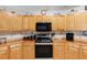 Modern kitchen features stainless steel appliances and wood cabinetry at 2821 Se 80Th St, Ocala, FL 34480