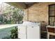 Exterior laundry room with washer, dryer and sink at 2821 Se 80Th St, Ocala, FL 34480