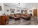 Spacious living room featuring a large sectional sofa and wood-look flooring at 2821 Se 80Th St, Ocala, FL 34480