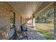Brick porch with comfortable seating overlooking the yard at 2821 Se 80Th St, Ocala, FL 34480
