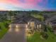 Stunning home at sunset, showcasing curb appeal and location at 3416 Eisenhower Way, The Villages, FL 32163
