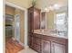 Bathroom with granite vanity and linen storage at 3416 Eisenhower Way, The Villages, FL 32163