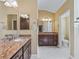 Double vanity bathroom with granite counters at 3416 Eisenhower Way, The Villages, FL 32163