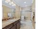 Updated bathroom with granite countertop and walk-in shower at 3416 Eisenhower Way, The Villages, FL 32163