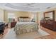 Main bedroom with hardwood floors, ample closet space, and ensuite bathroom at 3416 Eisenhower Way, The Villages, FL 32163