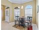 Bright breakfast nook with arched windows and seating for four at 3416 Eisenhower Way, The Villages, FL 32163