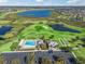 Aerial view of community pool, clubhouse, and golf course at 3416 Eisenhower Way, The Villages, FL 32163