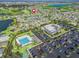 Aerial view of community amenities including pool, clubhouse, and parking at 3416 Eisenhower Way, The Villages, FL 32163