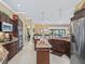 Open kitchen island with granite countertops and stainless steel appliances at 3416 Eisenhower Way, The Villages, FL 32163